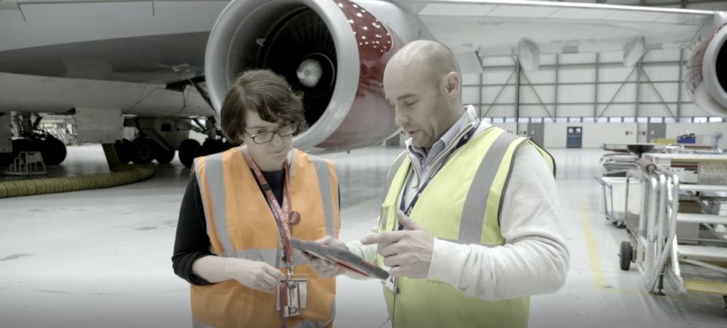 Two Virgin Atlantic workers in front of plane