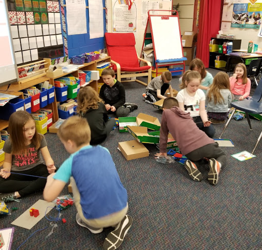 Students cooperatively building a variety of objects using Building Brick Challenge Kits.